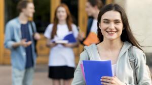 Prospective student in front of a building