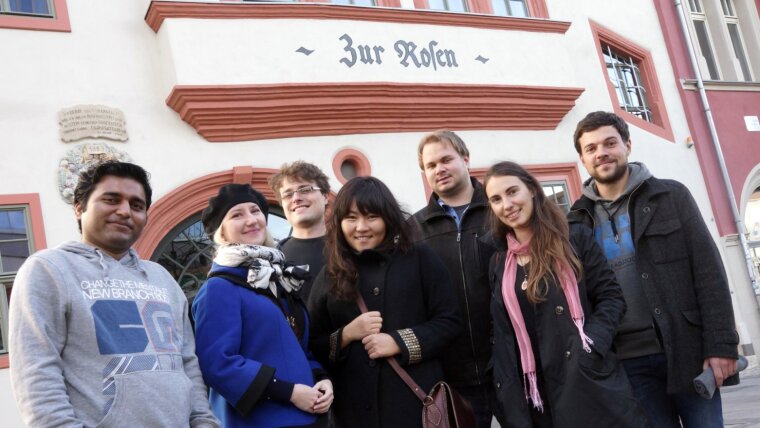 Promovierende stehen vor dem Haus „Zur Rosen“, Sitz der Graduierten-Akademie