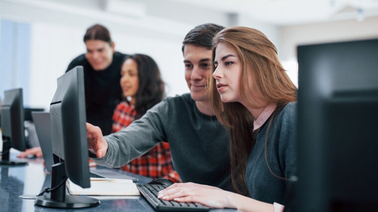 Prospective students do research on a computer