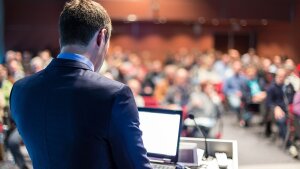 Postdoc giving a lecture in front of a big audience