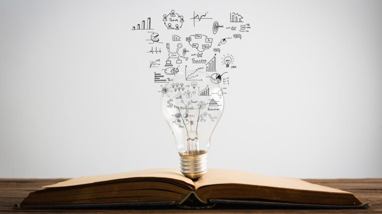 Book with a light bulb from which many symbols rise up