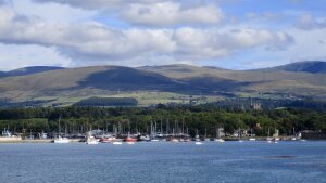 view of boats, sea, and Eryri mountains from Bangor Pier