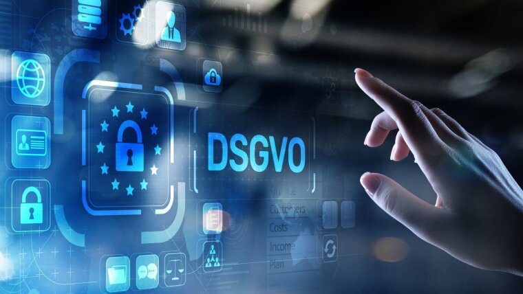 Hand points to data protection symbols. The abbreviation DSGVO can be read.