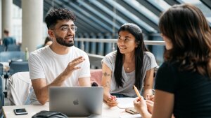 Three students talking to each other