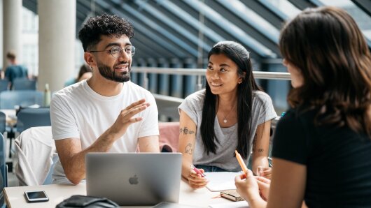 Three students talking to each other