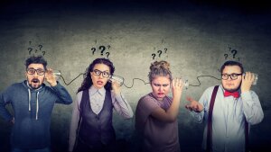 Four young people try to understand each other via a string telephone