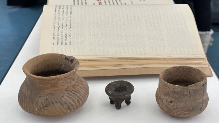View of the exhibition with excavation artefacts and documents.