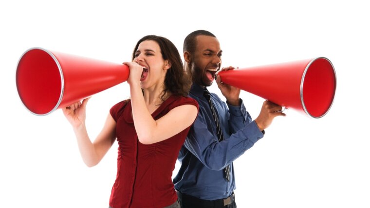 Woman and man speak into a megaphone.