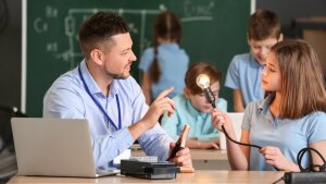 Ein Lehrer erklärt einer Schülerin ein physikalisches Phänomen.