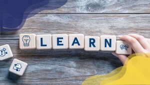 Wooden Blocks Spelling 'LEARN' with Educational Icons