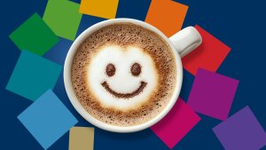 Colourful squares representing the faculties fly around a coffee cup with a smiling smiley face.