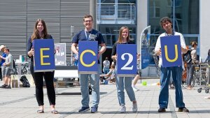 Studierende halten die Buchstaben der Universitätsallianz EC2U