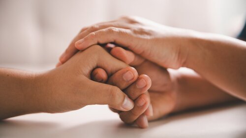 Two hands hold on tight