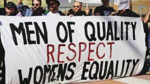 Men with a demonstration banner reading ‘Men of Quality respect Women's Equality.’