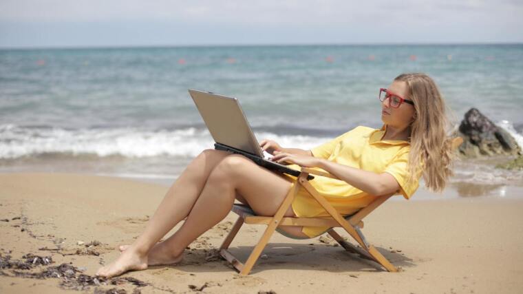 Woman with notebook at the beach