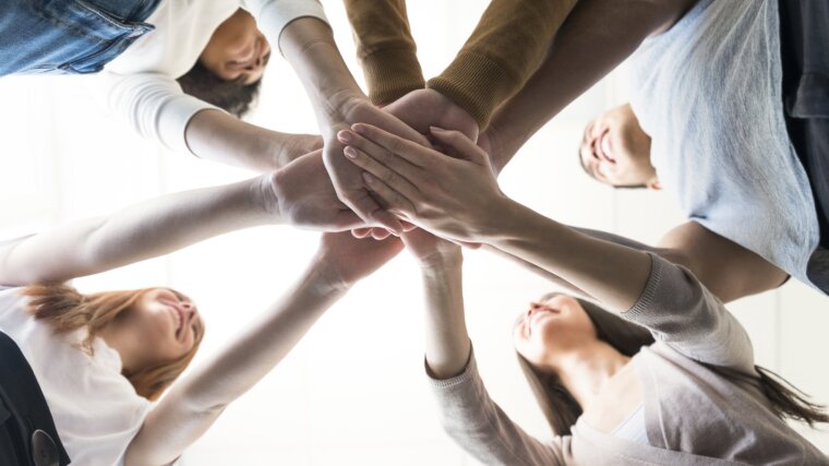 Students holding their hands together