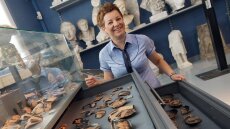 A young woman deals with antique shards in the antique collection of the University of Jena