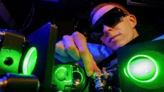 A young doctoral student adjusts a laser amplifier in a laboratory at the Institute of Applied Physics at Jena University
