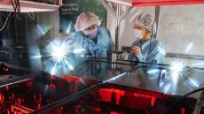 Two researchers conduct experiments with quantum dots and nanowires