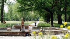 Young people at a fountain in the Saale floodplain in Jena Paradise