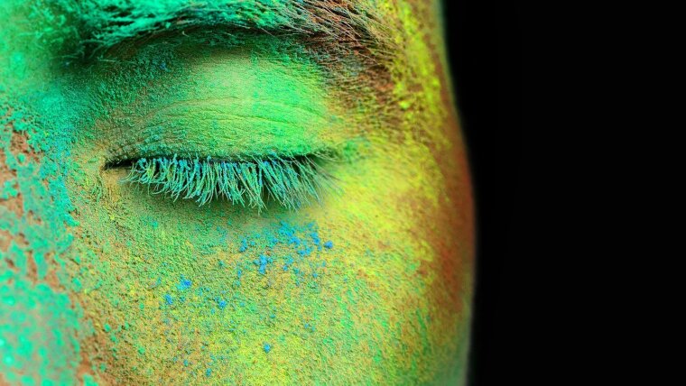 Part of face fully covered with bright holi paint