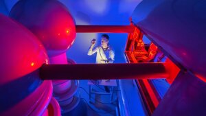 PhD student Christian T. Plass looks at a sample produced with the ion accelerator.