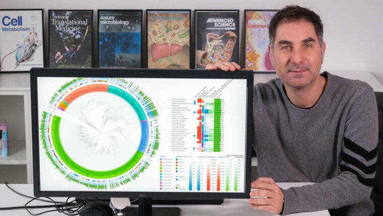 Gianni Panagiotou with a graphic showing the composition of the patient's microbiome in the study.