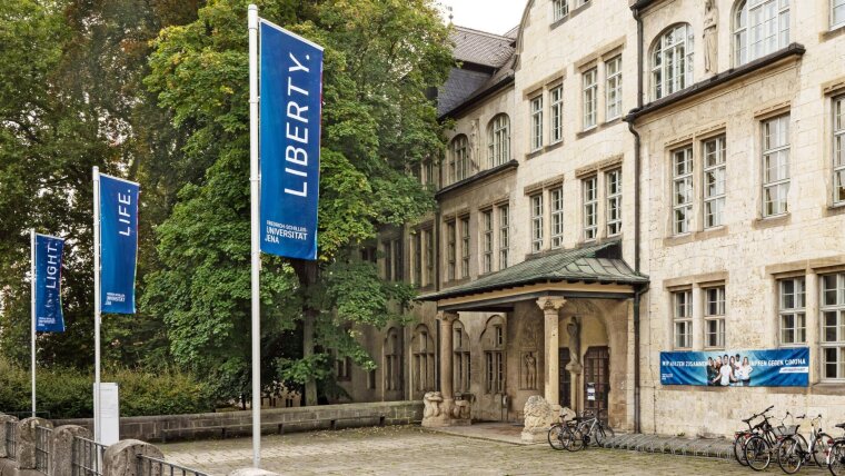 Flags with the slogan "Light, Life, Liberty" at the main building of the Friedrich Schiller University Jena