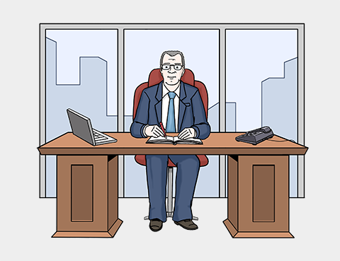Ein Mann sitzt in einem Büro am Schreibtisch. Auf dem Schreibtisch stehen ein Computer und ein Telefon. Hinter dem Mann ist ein großes Fenster mit vielen Gebäuden.