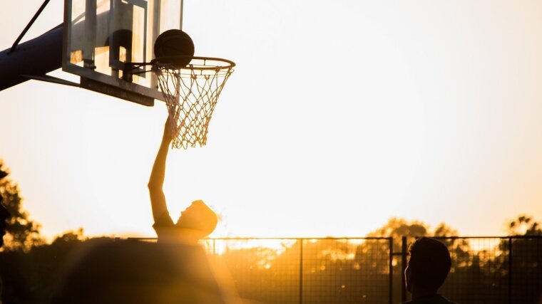 A basketball player scores a goal