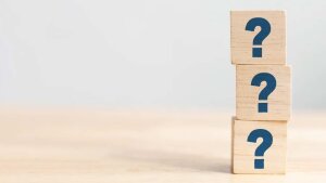 Three dice with question marks and stacked on top of each other