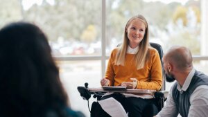 Female student in wheelchair speaks in seminar group