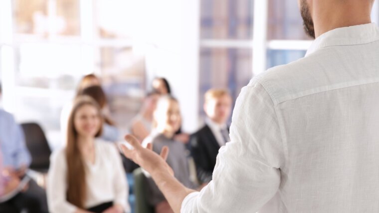 A lecturer explaining something to students.