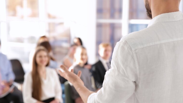 A lecturer explaining something to students.