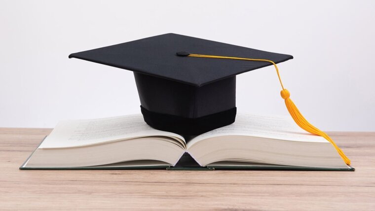 Doctoral hat laying on a book