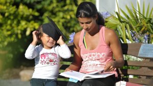 Mother with child who wears a doctoral hat