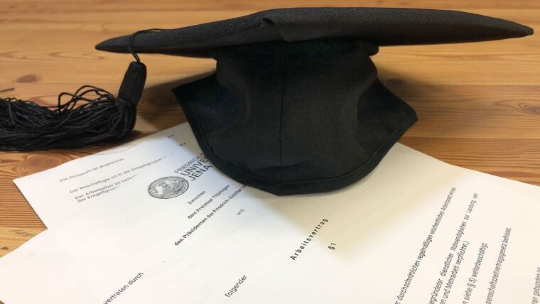 Doctoral hat with working contract
